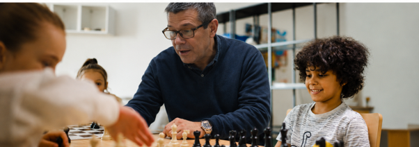 Ramon Rodriguez teaching chess to students.
